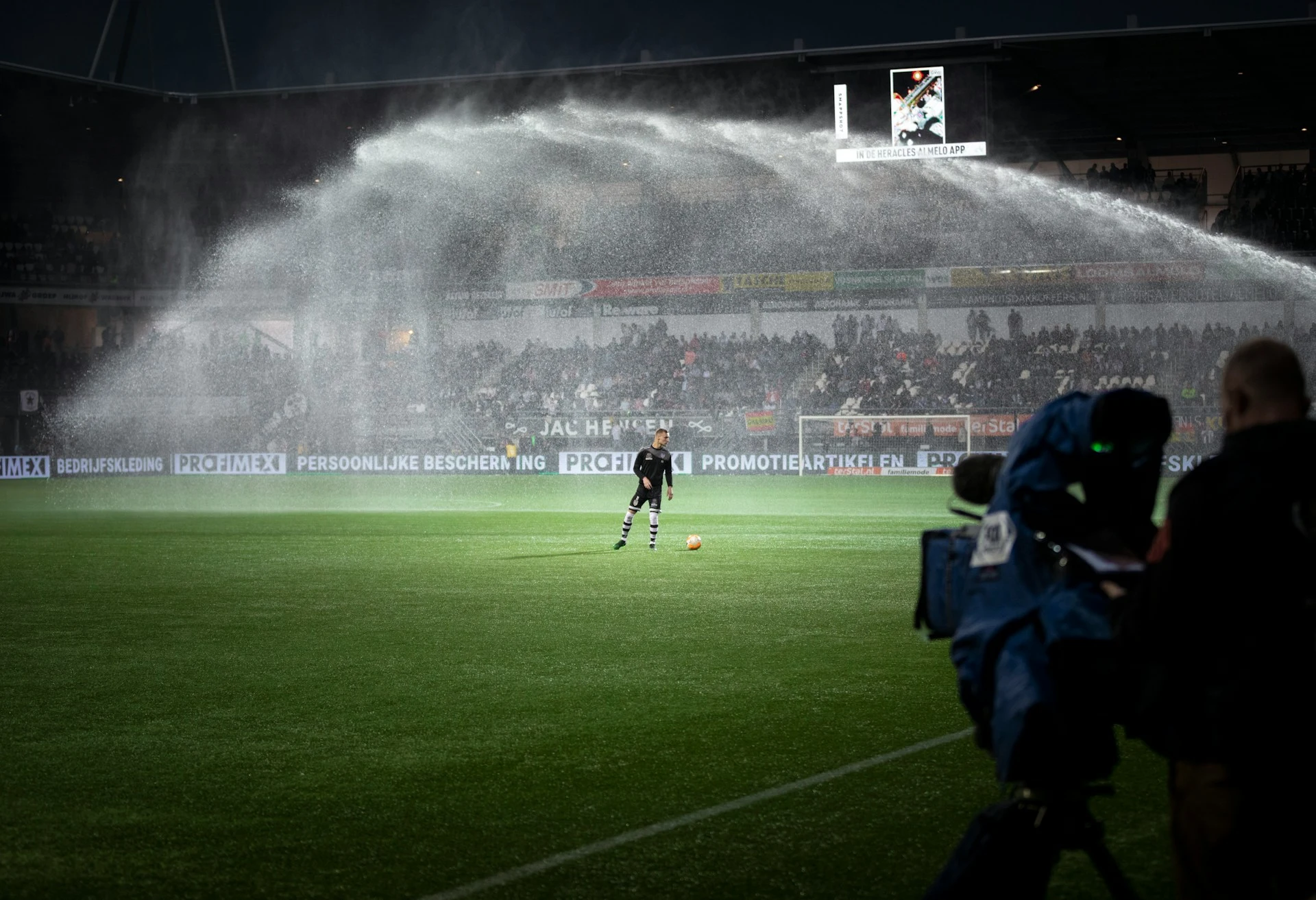 Soccer player on field with crowd watching